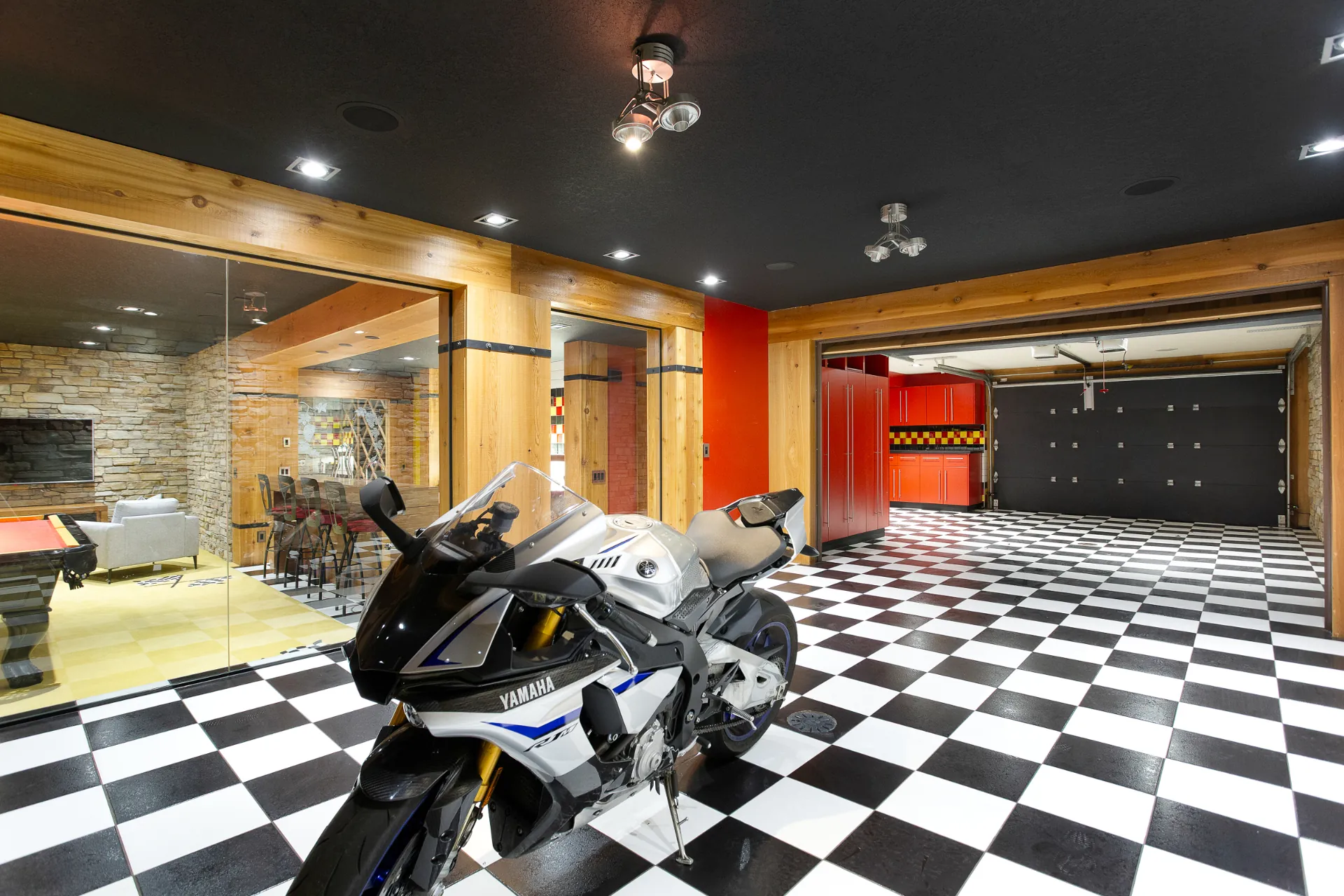 Showroom garage with checkered floor behind a glass wall