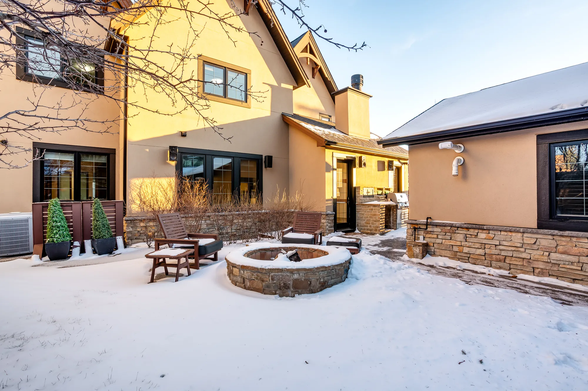 Treed rear yard and patio with stone fire pit