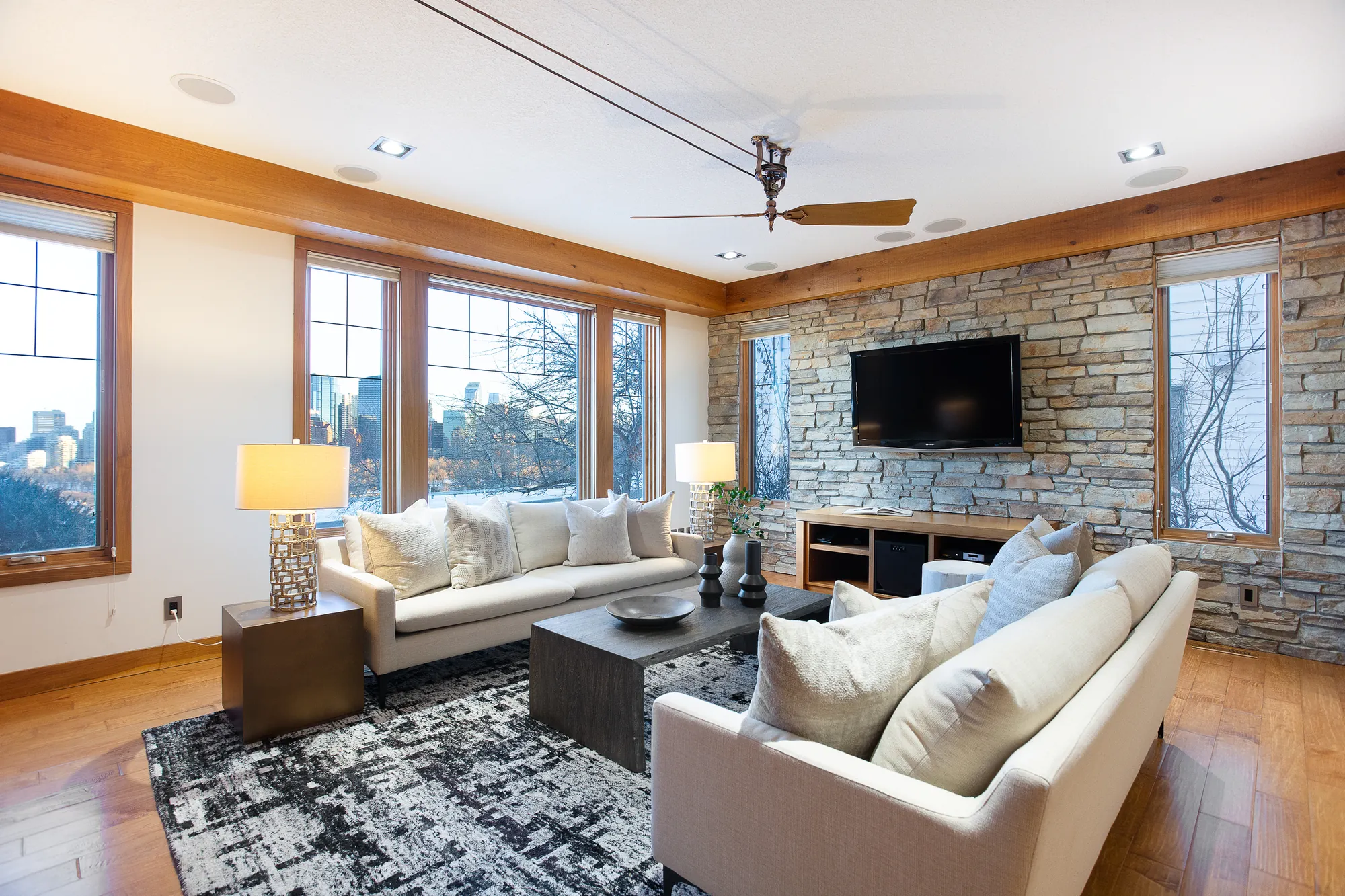 Living room with stone fireplace and downtown view